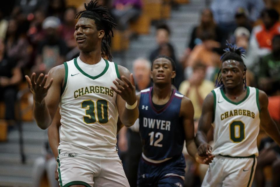 Suncoast's Ian Smikle (30) and Stone Bureau (0) face Dwyer in boys high school basketball action in Riviera Beach, Fla., on January 25, 2023. Dwyer won 46-45 over Suncoast.