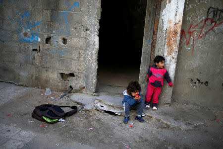 Palestinian children look on outside their house at Shati refugee camp in Gaza City March 14, 2018. REUTERS/Mohammed Salem