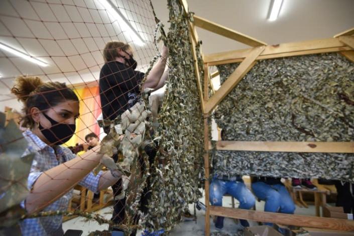 Armenian women in Yerevan make camouflage netting tobe sent to a frontline in Karabakh