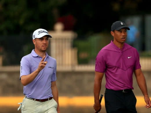 Tiger Woods and  Justin Thomas walk up the 18th hole during the first round of the PNC Championship (Getty)