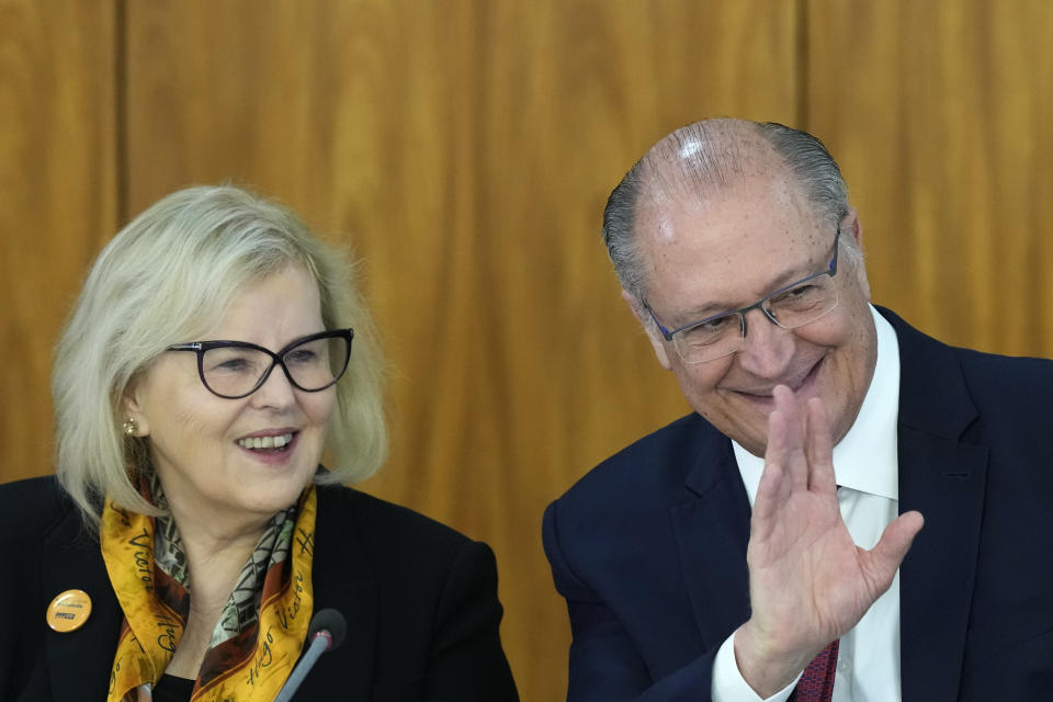 Brazil's Vice President Geraldo Alckmin waves accompanied by Supreme Court President Rosa Weber, during a meeting regarding school security, at the Planalto Palace in Brasilia, Brazil, Tuesday, April 18, 2023. Educators, government security officials and school administrators have gathered to devise plans to deal with a wave of school violence that has left at least 4 children and one teacher dead. (AP Photo/Eraldo Peres)