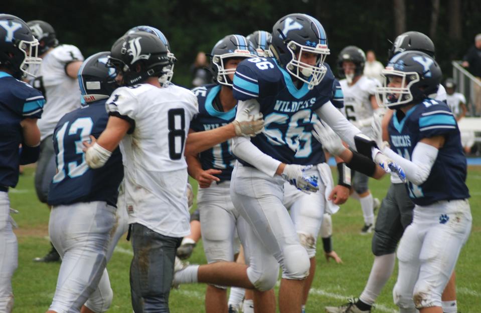 York's Trey Fogg (66) celebrates a tackle for loss with teammates Ben Brown (13), JJ Luchette (11) and Nicholas Beaulieu (15) during Saturday's 41-20 win over Lisbon.