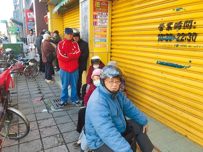 排在領取口罩隊伍最前面的民眾，還自帶小椅子。（胡健森攝）