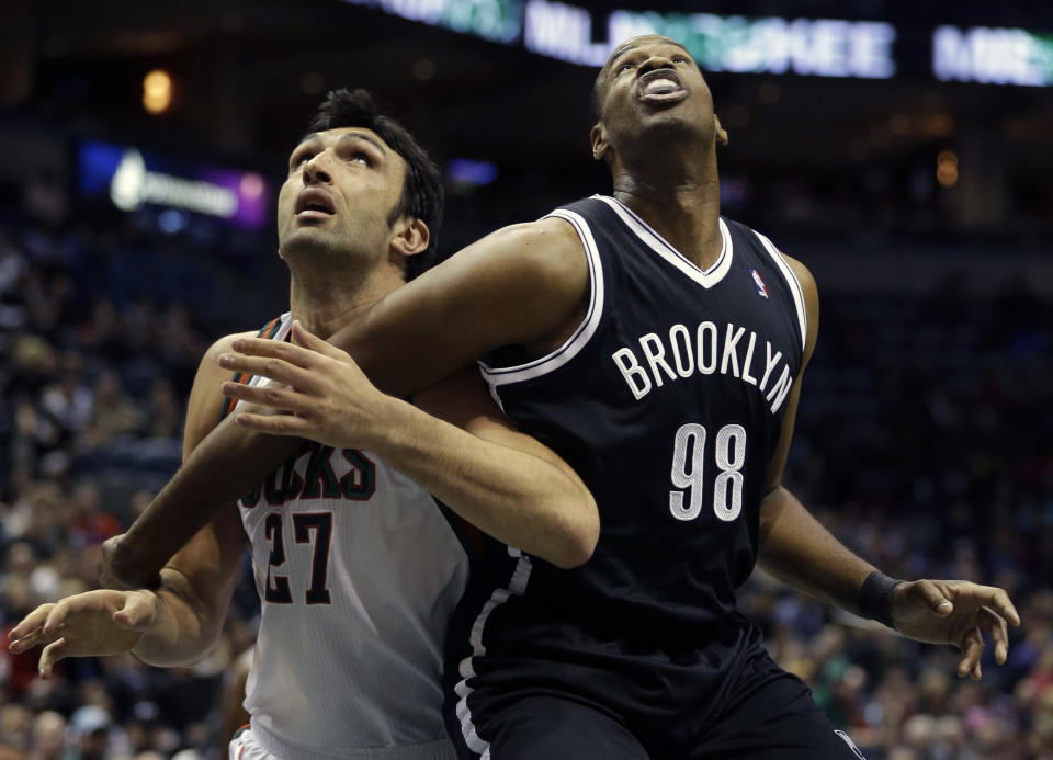 Brooklyn Nets' Jason Collins (98) and Milwaukee Bucks' ZaZa Pachulia, left, look for a rebound in the first half of an NBA basketball game, Saturday, March 1, 2014, in Milwaukee. (AP Photo/Jeffrey Phelps)