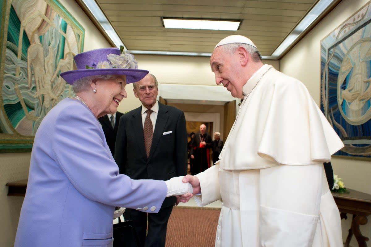 Pope Francis and Queen Elizabeth meet at the Vatican in 2014 (OSSERVATORE ROMANO/AFP via Getty)