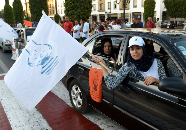 Supporters of the Justice and Development Party (PJD) wave party flags as they celebrate the results of Moroccan regional elections