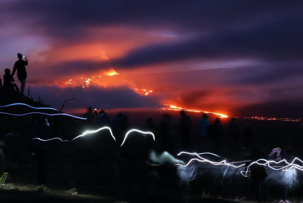 Hawaii's Mauna Loa's volcano is erupting for the first time in nearly 40 years. <a href="https://www.gettyimages.com/detail/news-photo/people-gather-on-top-of-a-hill-to-watch-mauna-loa-erupts-news-photo/1245294420?phrase=mauna%20loa&adppopup=true" rel="nofollow noopener" target="_blank" data-ylk="slk:Tayfun Coskun/Anadolu Agency via Getty Images;elm:context_link;itc:0;sec:content-canvas" class="link ">Tayfun Coskun/Anadolu Agency via Getty Images</a>