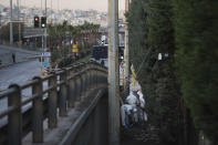 Greek forensic experts search at the scene after a powerful bomb exploded outside private Greek television station Skai, in Faliro, Athens, on Monday, Dec, 17, 2018. Police said the blast occurred outside the broadcasters' headquarters near Athens after telephoned warnings prompted authorities to evacuate the building, causing extensive damage but no injuries. (AP Photo/Petros Giannakouris)