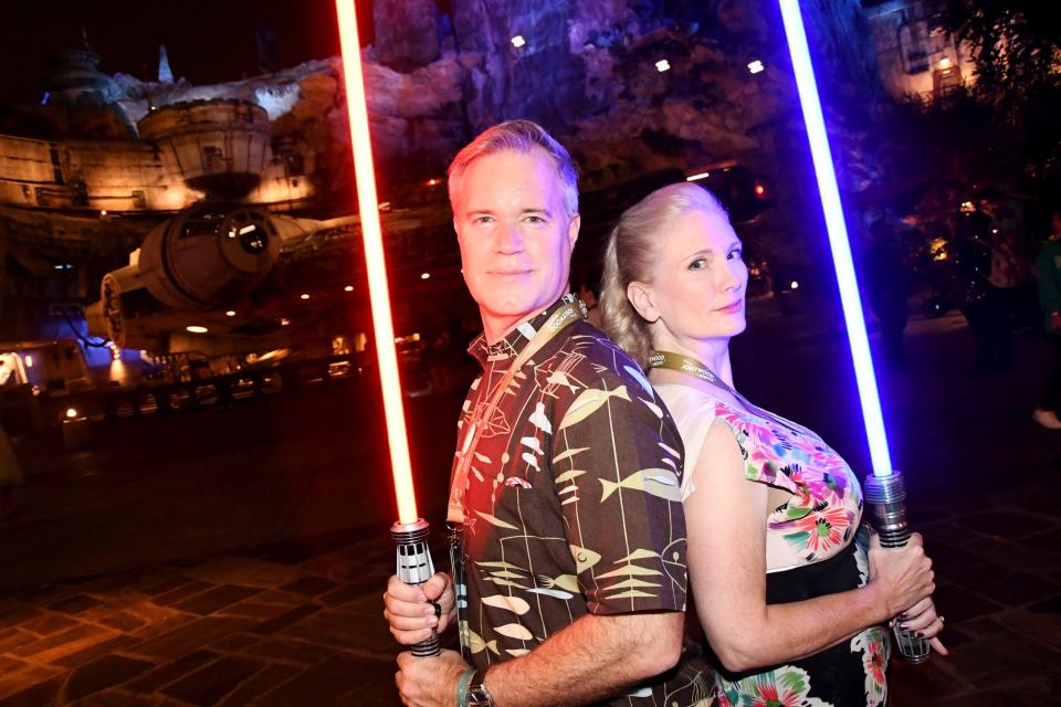 On opening night of Jollywood Nights at Disney's Hollywood Studios, photographers were on hand to take Jedi-themed photos in front of the Millennium Falcon in Star Wars: Galaxy's Edge. Pictured are FLORIDA TODAY's Christina LaFortune, right, and her husband Mike.