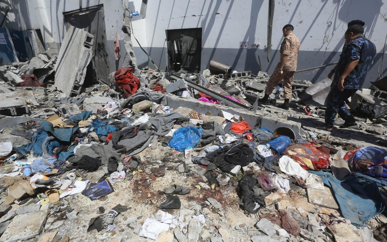 The bloody clothes of migrants killed in an air strike on a detention centre on Libya last week. At least 53 were killed - REX