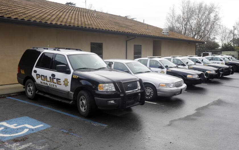 Patrol cars are lined up at the King City Police Deptment on Wednesday, Feb. 26, 2014, in King City, Calif. The acting police chief and two officers in King City were removed from duty after being arrested on suspicion of selling or giving away the impounded cars of poor residents, authorities said. (AP Photo/Marcio Jose Sanchez)