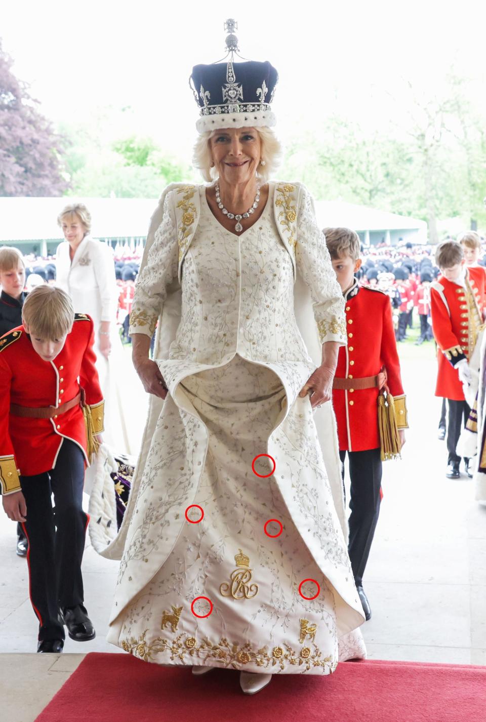 Queen Camilla had the names of her children and grandchildren embroidered onto the bottom of her coronation dress, alongside a tribute to her rescue dogs (PA/Getty Images)