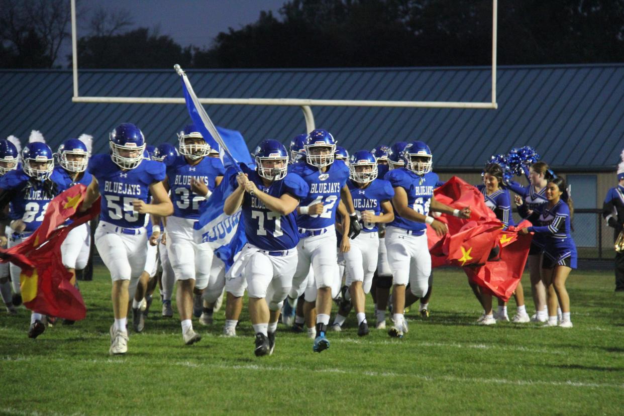 Perry players run onto Dewey Field during a homecoming game against Nevada on Friday, Sept. 22, 2023.
