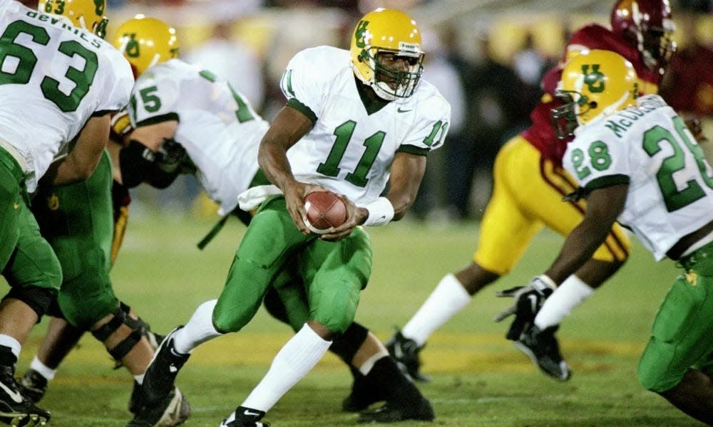 Former Oregon Duck Akili Smith (11) was a two-year standout quarterback for the Ducks and the 1998 Pac-12 co-offensive player of the year.