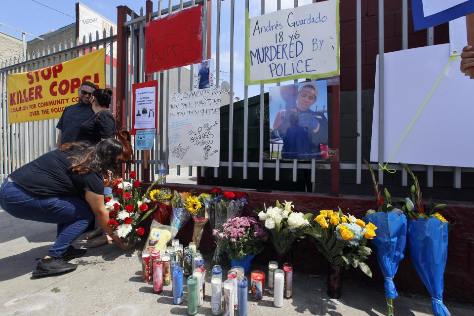 Friends leave candles and flowers at a makeshift memorial for Andres Guardado on Friday in Gardena, California, near where he was fatally shot by a Los Angeles County sheriff's deputy. (Photo: AP Photo/Damian Dovarganes)