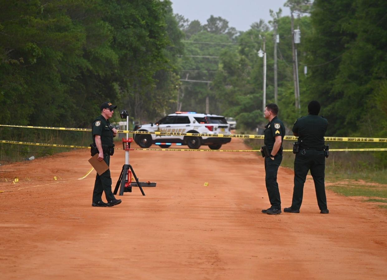 Walton County sheriff's officials at the scene of an early morning shooting in Mossy Head that injured a child.