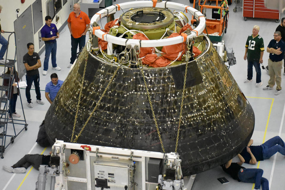 Engineers inspect the Orion spacecraft following the unmanned Artemis 1 mission in late 2022. NASA is still evaluating an issue with the heat shield discovered after capsule reentry that contributed to delaying the program's next flight.  / Credit: NASA