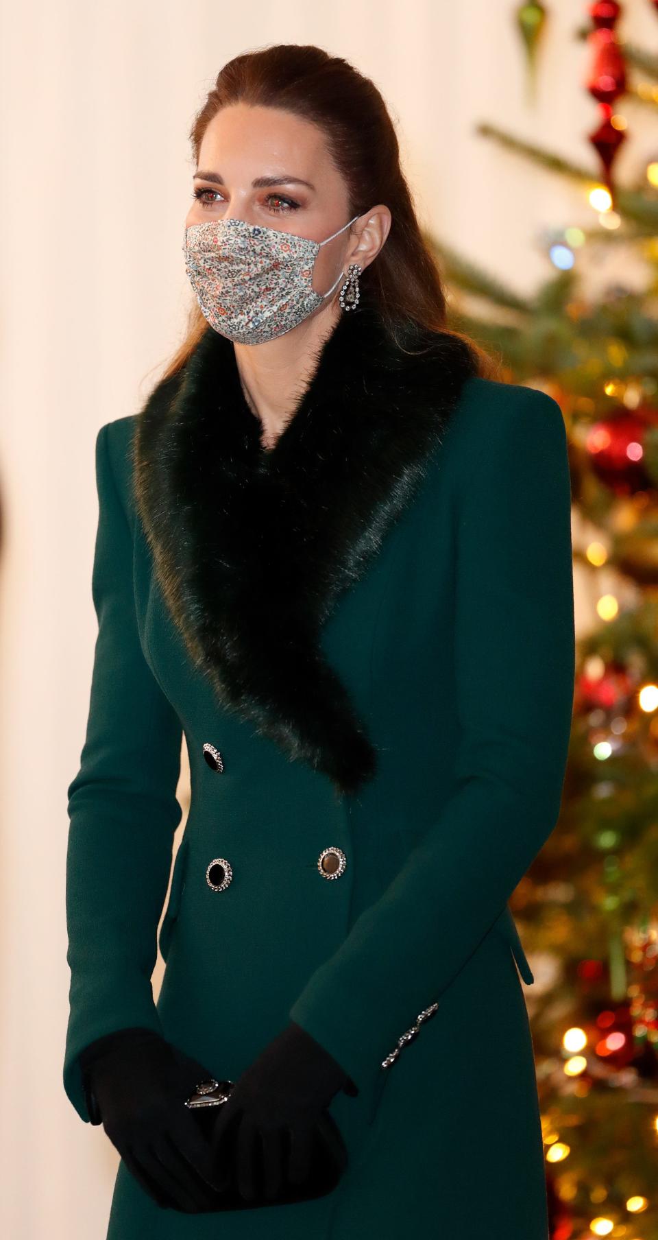 Kate Middleton wears a green coat and face mask in December 2020.