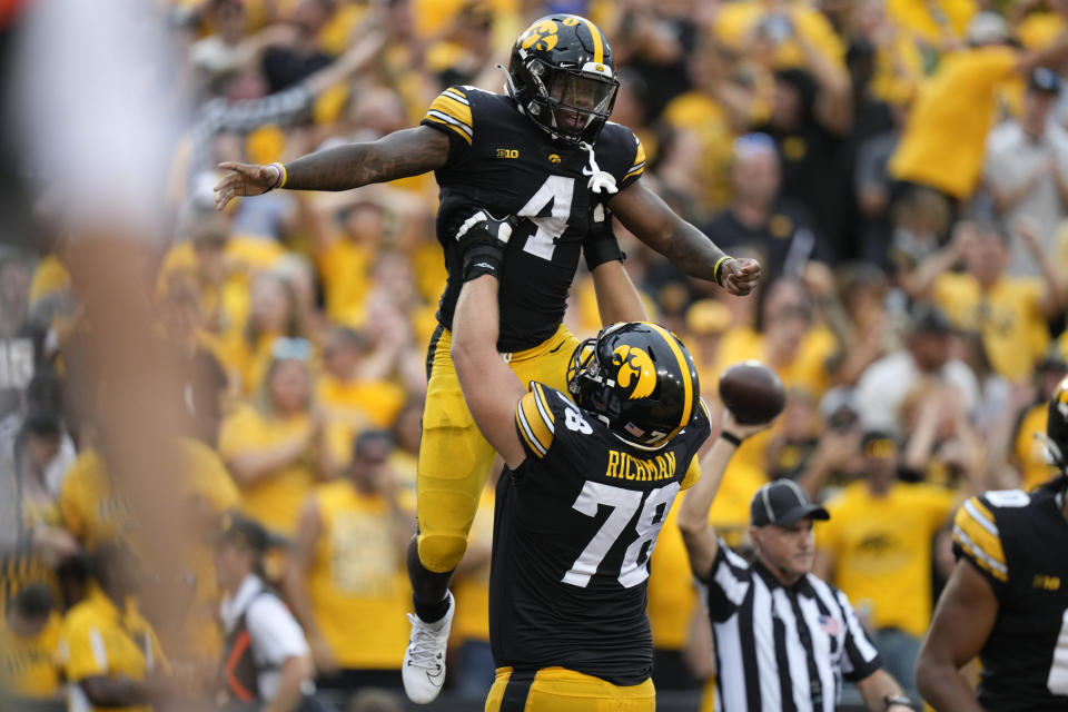 Iowa running back Leshon Williams (4) celebrates with teammate offensive lineman Mason Richman (78) after catching a 25-yard touchdown pass during the first half of an NCAA college football game against Western Michigan, Saturday, Sept. 16, 2023, in Iowa City, Iowa. (AP Photo/Charlie Neibergall)