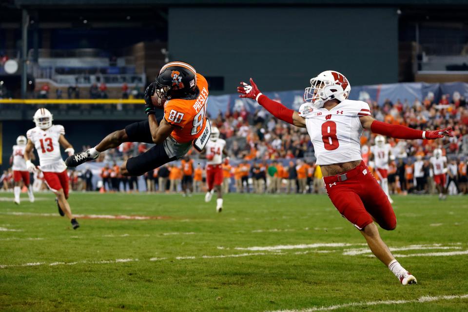 Oklahoma State receiver Brennan Presley makes a leaping catch against Wisconsin in the 2022 Guaranteed Rate Bowl. Presley returns as one of the top slot receivers in the nation.