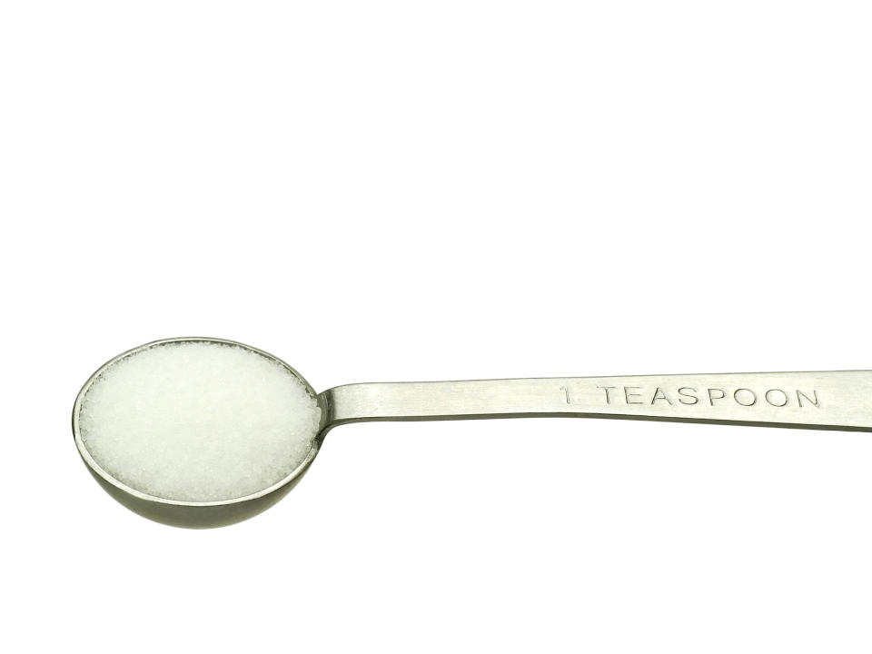 Studio isolated shot of salt in a teaspoon, includes clipping path.