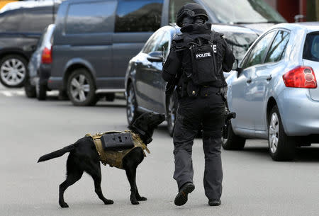 Police officer with a service dog is seen after a shooting in Utrecht, Netherlands, March 18, 2019. REUTERS/Piroschka van de Wouw