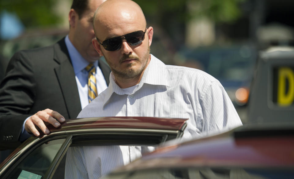 FILE - In this June 11, 2014, file photo, former Blackwater Worldwide guard Nicholas Slatten enters a taxi cab as he leaves federal court in Washington, after the start of his trial. A federal judge has sentenced a former Blackwater security contractor to life in prison for his role in the 2007 shooting of unarmed civilians in Iraq. (AP Photo/Cliff Owen, File)