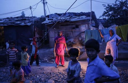 Fifty-five-year-old Subna Bi (C), poses for a picture outside her house next to the abandoned former Union Carbide Corp pesticide plant in Bhopal November 15, 2014. REUTERS/Danish Siddiqui