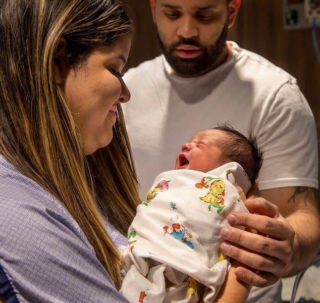 Aaron Delacruzgainza may have been the first baby born in New Jersey in 2024. He arrived at midnight on Jan. 1 at Holy Name Medical Center. Mother Solanne Delacruzgainza holds little Aaron while his father Jose Carlos Pena Lopez looks on.