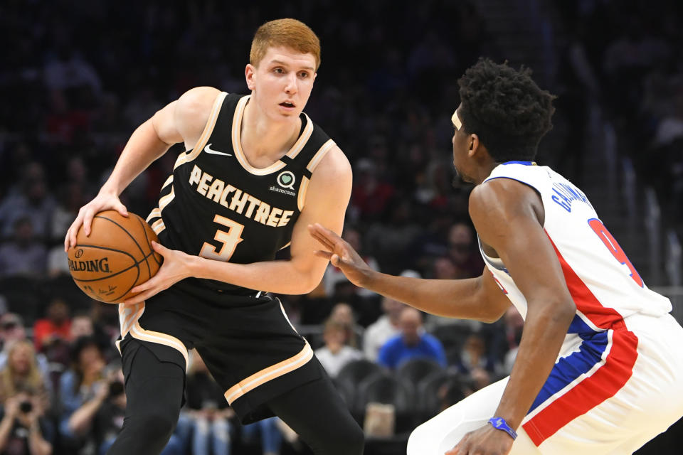 Atlanta Hawks guard Kevin Huerter (3) is defended by Detroit Pistons guard Langston Galloway during the first half of an NBA basketball game Saturday, Jan. 18, 2020, in Atlanta. (AP Photo/John Amis)