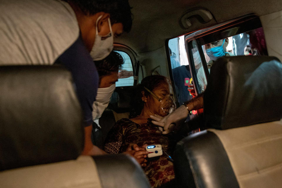 A volunteer performs CPR on a woman with breathing problems in Ghaziabad, Uttar Pradesh, on April 24.<span class="copyright">Danish Siddiqui—Reuters</span>