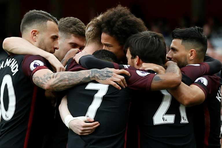 Teammates congratulate Manchester City's Leroy Sane (C) after he sored the opening goal during their English Premier League match against Arsenal, at The Emirates Stadium in London, on April 2, 2017