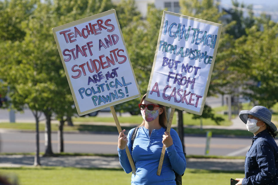 Art teacher Cara Bailey attends a Utah Safe Schools Mask-In urging the governor's leadership in school reopening during a rally Thursday, July 23, 2020, in Salt Lake City. Parents and teachers rallied at the Utah State Capitol Thursday morning to urge schools to enforce mask wearing and to implement other safety policies recommended by health officials as the state prepares to reopen classrooms this fall. (AP Photo/Rick Bowmer)