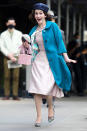 <p>Brosnahan sported a bright turquoise coat, a pale pink dress and a huge smile on set on May 17. </p>