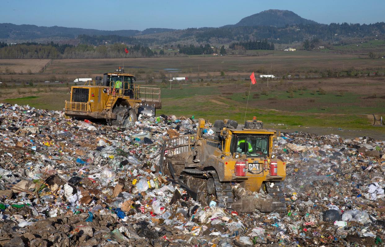 Heavy equipment spreads and compacts garbage at the Short Mountain Landfill south of Eugene. 