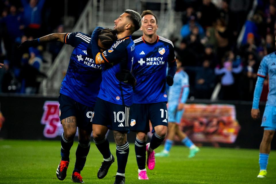 FC Cincinnati midfielder Luciano Acosta (10) embraces FC Cincinnati forward Aaron Boupendza (9) after scoring a goal in the second half of the match between FC Cincinnati and New York City FC at in Cincinnati on Saturday, March 23, 2024.