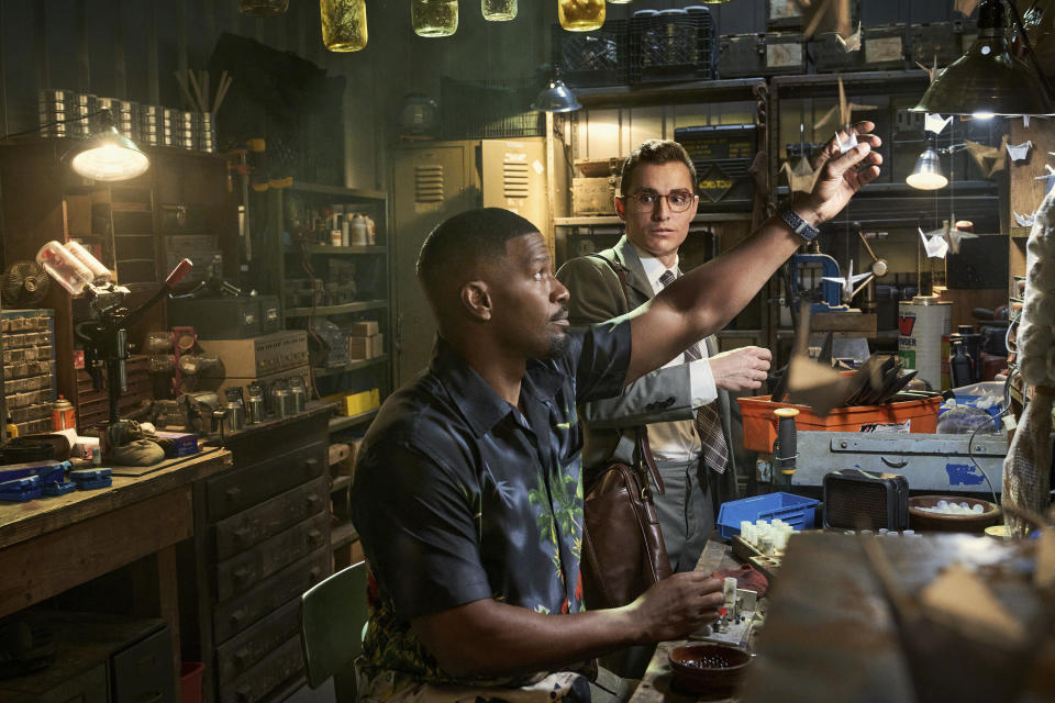 This image released by Netflix shows Jamie Foxx, left, and Dave Franco in a scene from "Day Shift." (Parrish Lewis/Netflix via AP)