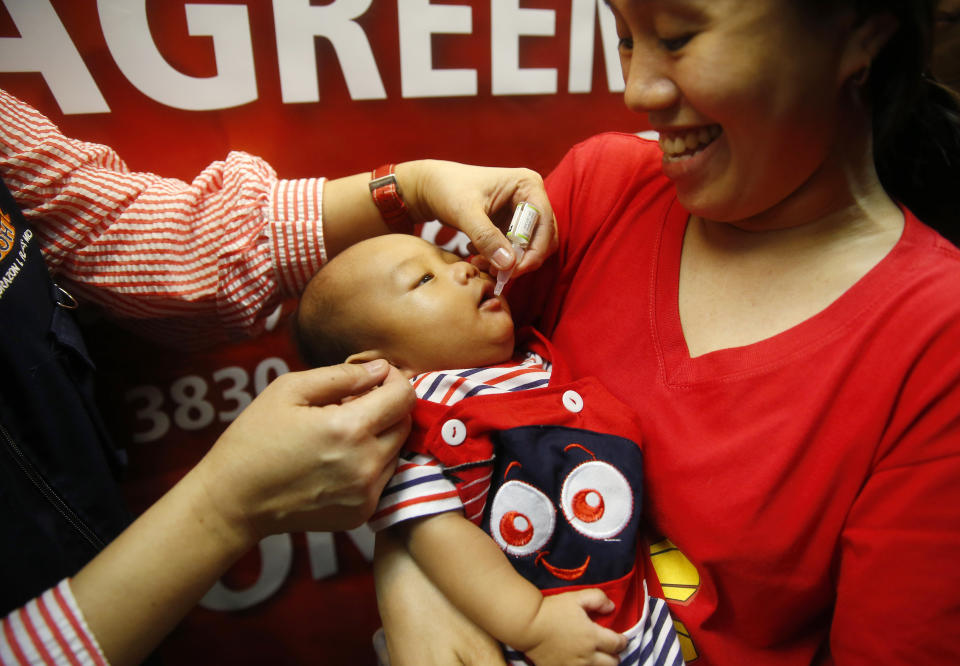 FILE- In this Sept. 20, 2019 photo, a baby gets an oral anti-polio vaccine during the launch of a campaign to end the resurgence of polio after health authorities confirmed a polio case in the country in Quezon city, Philippines. A polio outbreak in the Philippines has ended, according to the World Health Organization and the United Nations Children's Fund, Friday June 11, 2021 which praised government efforts to fight the disease despite the coronavirus pandemic. (AP Photo/Bullit Marquez)