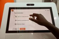 A man performs a financial transaction at a bank of the French mobile operator Orange in Abidjan, Ivory Coast