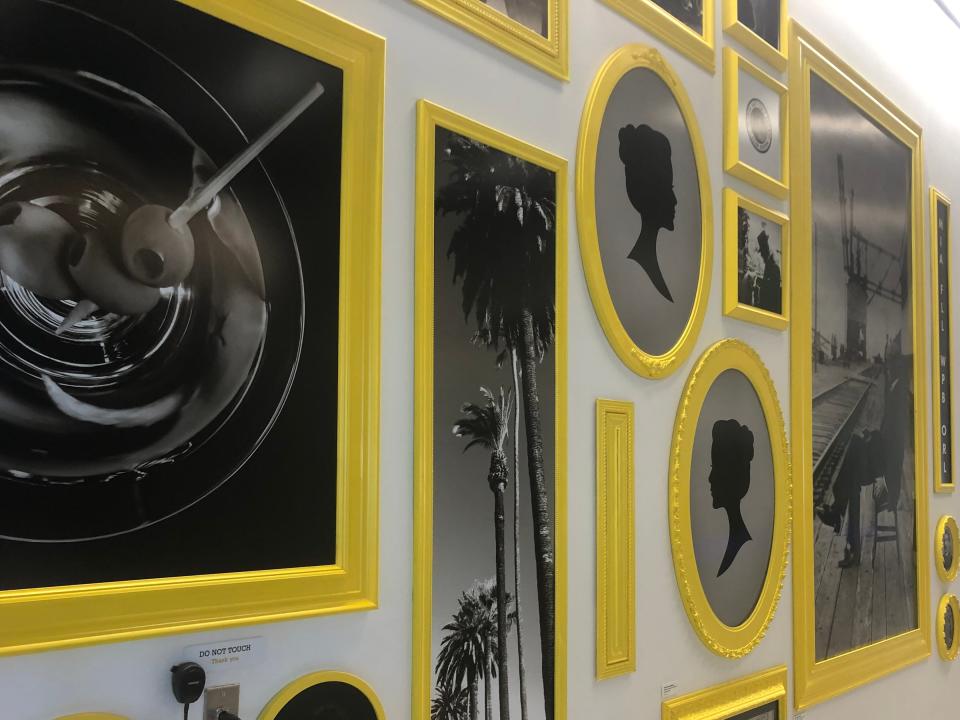 A collection of black and white photos in bright yellow frames.