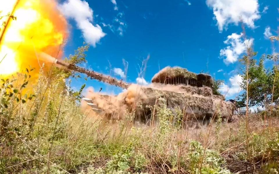 A Russian T-80 tank fires towards Avdiivka