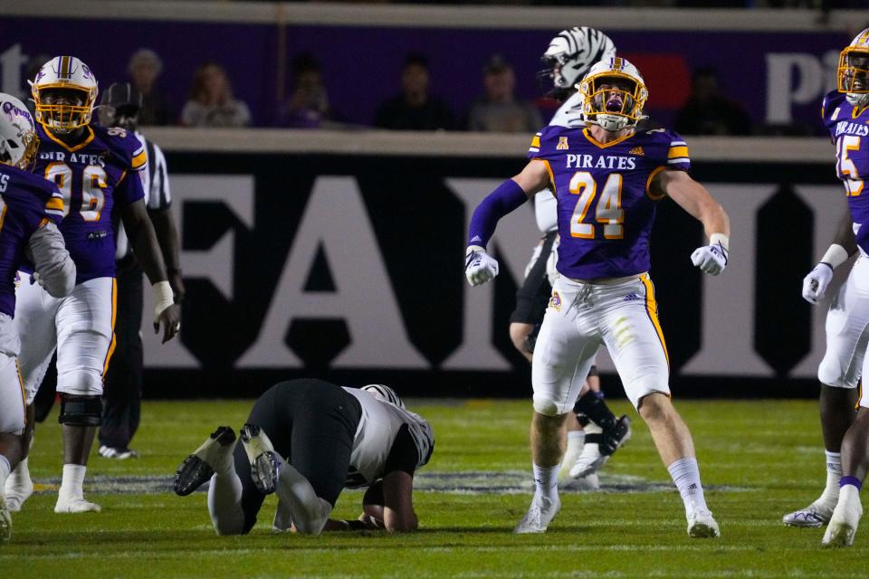 Oct 15, 2022; Greenville, North Carolina, USA;  East Carolina Pirates linebacker Jack Powers (24) celebrates his sack of Memphis Tigers quarterback Seth Henigan (5) during the first half at Dowdy-Ficklen Stadium. Mandatory Credit: James Guillory-USA TODAY Sports