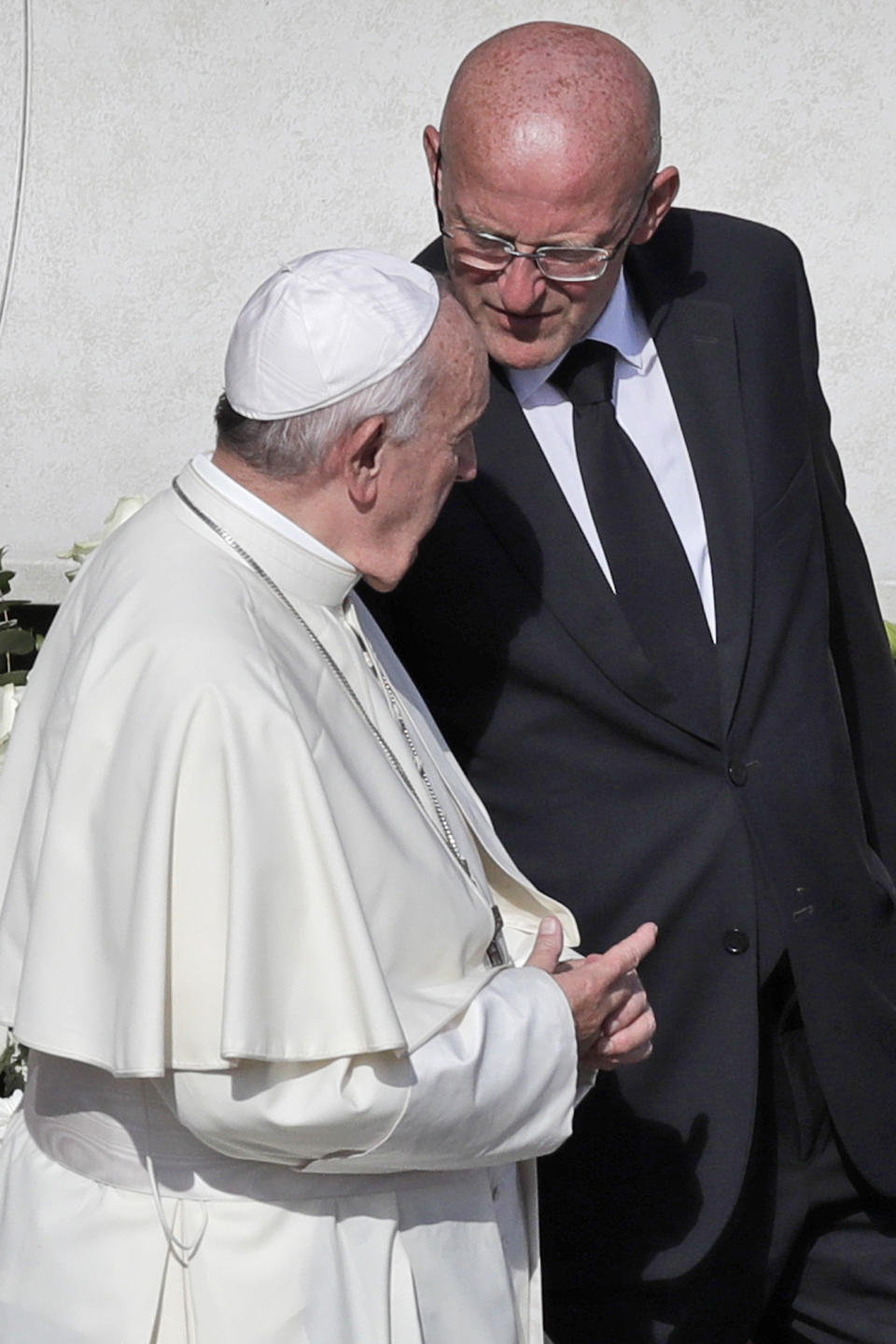Vatican head of security Domenico Giani, right, shares a word with Pope Francis at the end of a canonization Mass in St. Peter's Square at the Vatican, Sunday, Oct. 13, 2019. The Vatican said Monday Oct. 14, 2019 that Francis’ chief bodyguard Giani has resigned over the leak of a Vatican police flyer identifying five Holy See employees who were suspended as part of a financial investigation, adding that Giani bore no responsibility for the leak, but that he had resigned to ensure the serenity of the investigation and “out of love for the church and faithfulness” to the pope. (AP Photo/Alessandra Tarantino)