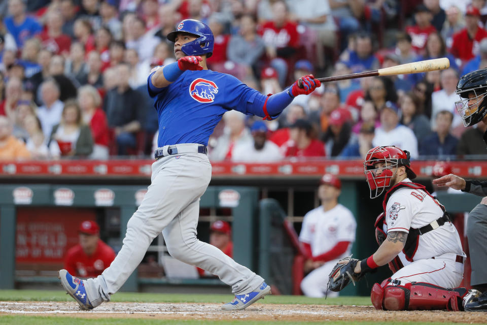 Chicago Cubs' Willson Contreras watches his RBI sacrifice fly off Cincinnati Reds starting pitcher Tanner Roark during the fifth inning of a baseball game Tuesday, May 14, 2019, in Cincinnati. (AP Photo/John Minchillo)