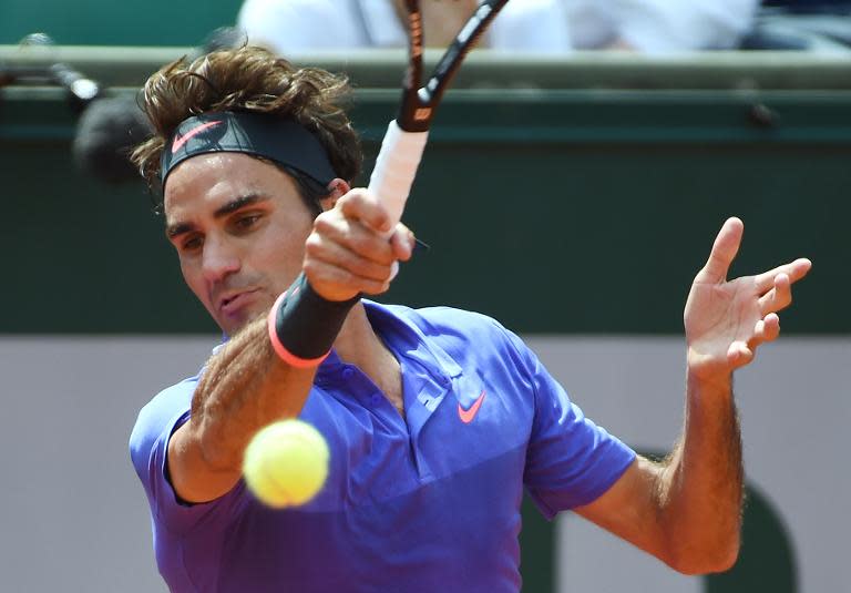 Roger Federer returns the ball to Marcel Granollers during their men's second round match in the French Open in Paris on May 27, 2015