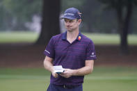 Justin Rose, of England, holds his scorecard on the 10th green after making a bogey during the first round of the Wyndham Championship golf tournament at Sedgefield Country Club on Thursday, Aug. 13, 2020, in Greensboro, N.C. (AP Photo/Chris Carlson)