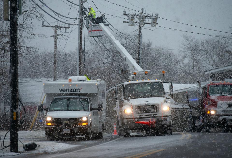 Verizon crews brave a heavy wet snowfall as they make repairs to downed service lines along Route 6A in West Barnstable as the storm picked up on Tuesday