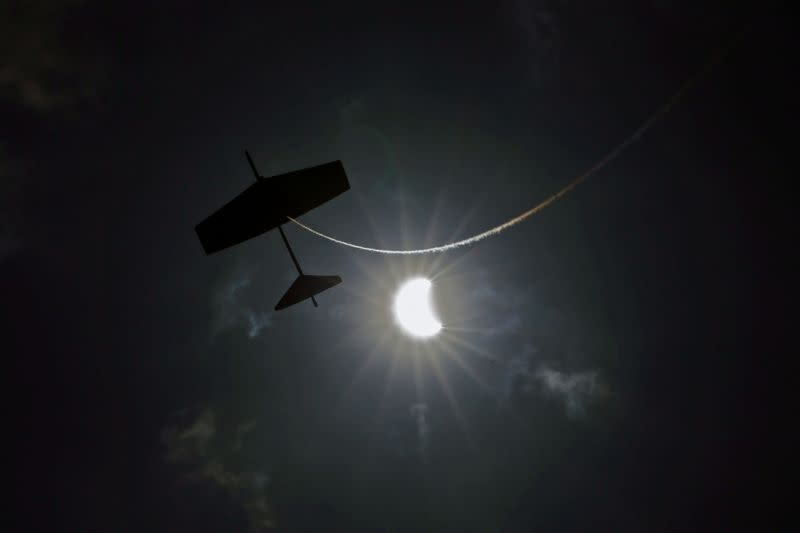 A kite flies during the annular solar eclipse in Siak