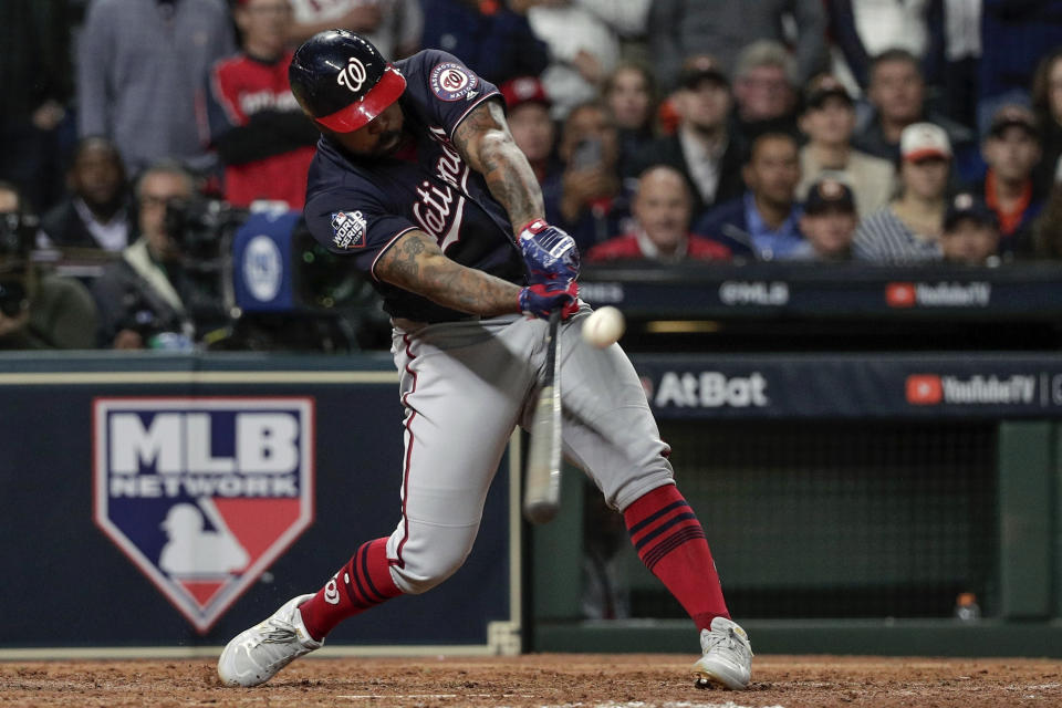 FILE - In this Oct. 30, 2019, file photo, Washington Nationals' Howie Kendrick hits a two-run home run during the seventh inning of Game 7 of the baseball World Series against the Houston Astros in Houston. Major League Baseball has proposed expanding the playoff field from 10 teams to as many as 16 for this year and next season. Other major sports are accustomed to more teams in the postseason. (AP Photo/David J. Phillip, File)