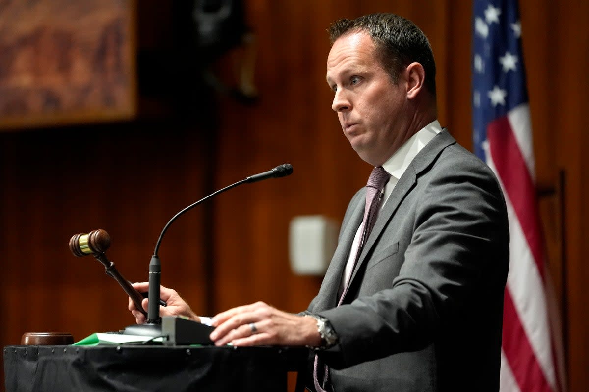 Arizona State Speaker pro tempore Travis Grantham calls for order on the House floor on Wednesday 17 April at the state Capitol in Phoenix (AP)